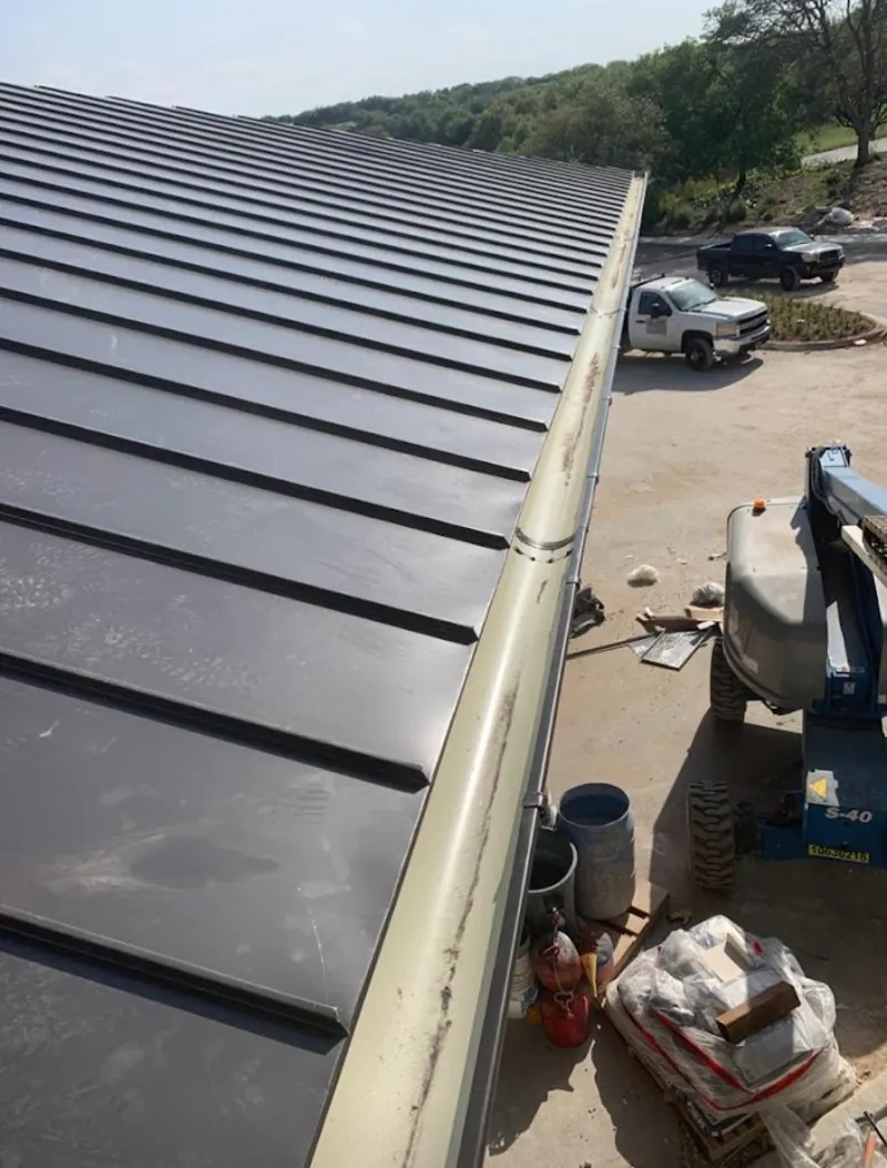 Standing seam panel and gutter detail on a metal roofing jobsite in South Patrick Shores
